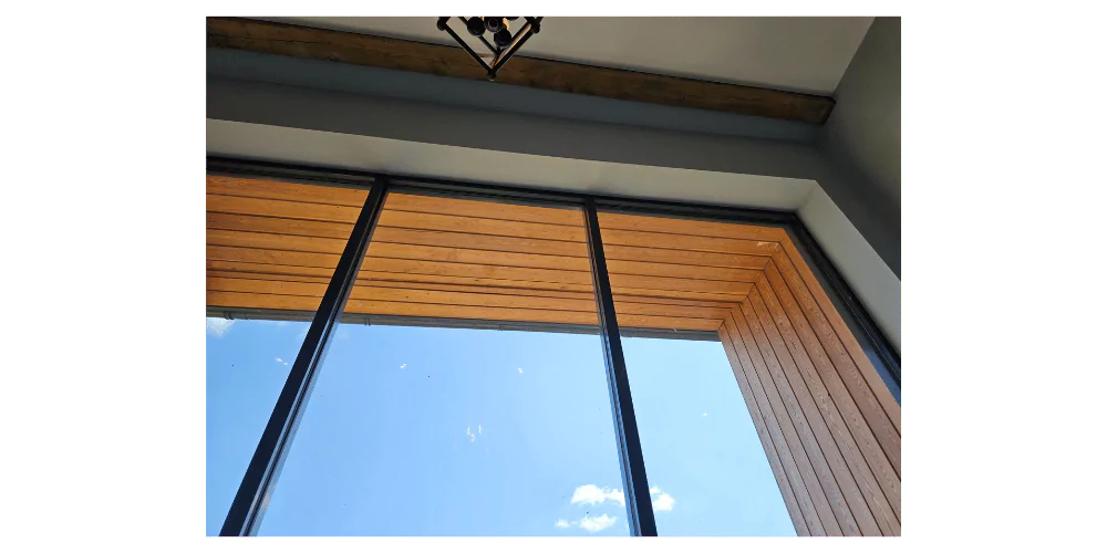 blue sky through a window with wooden window frame --- exterior house painting, spray painters near me, tile cutting service near me, tile installation