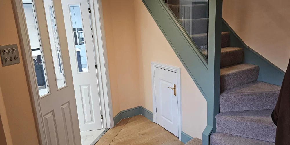 The bottom of staircase with hallway painted peach and green --- tilers near me kitchen cabinet painting, bathroom tile replacement